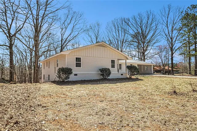 a view of a house with a yard covered in snow