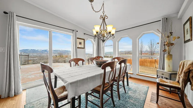 a dining room with furniture a chandelier and window