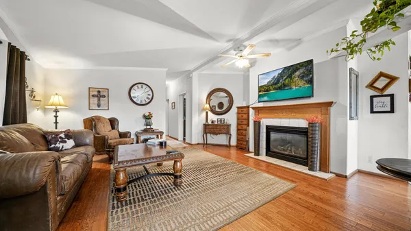 a living room with furniture a fireplace and a flat screen tv