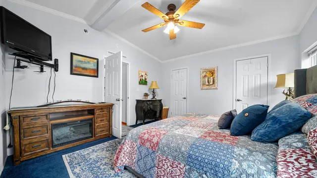 a bedroom with a bed and a television