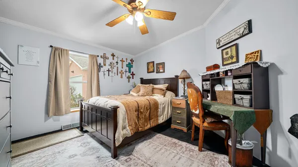 a bedroom with a bed a window and dresser