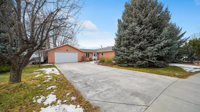 a front view of house with yard and trees around