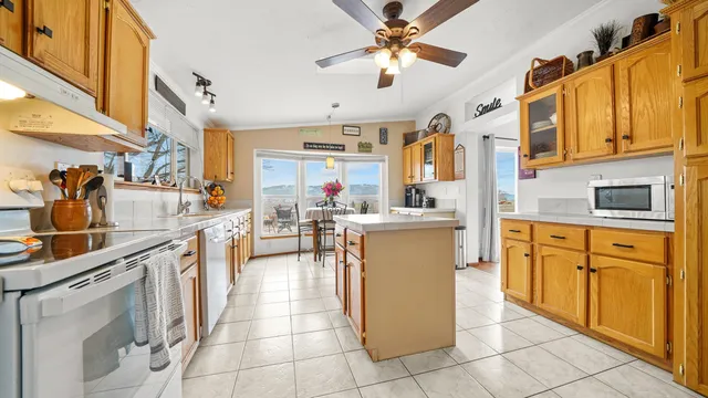 a kitchen filled with cabinets a sink and appliances