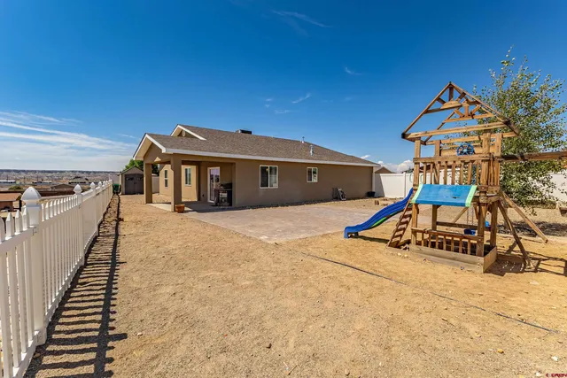 a view of a house with large trees