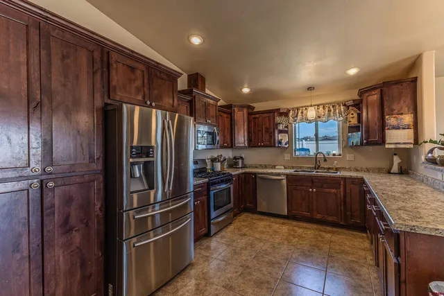 a kitchen with granite countertop stainless steel appliances and wooden cabinets