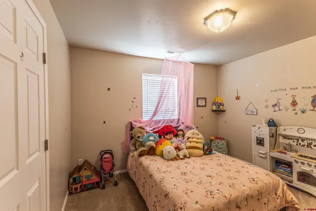 a bedroom with a bed and a dresser