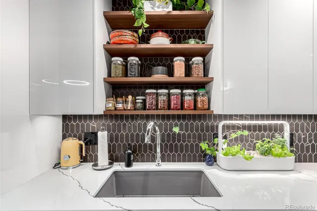 a kitchen with stainless steel appliances granite countertop a sink a stove and cabinets