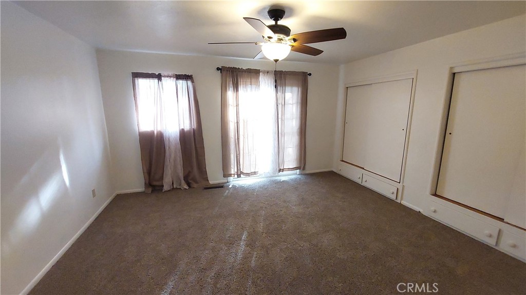 1909 Colusa Street Corning, CA 96021 - Photo 17 of 22 a view of a big room with windows and chandelier fan
