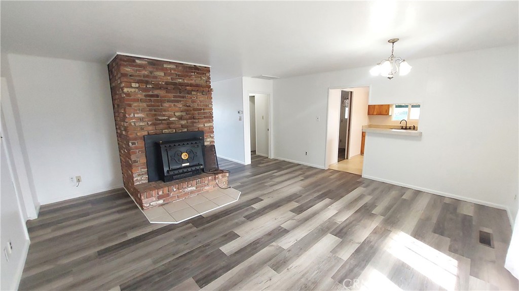 1909 Colusa Street Corning, CA 96021 - Photo 6 of 22 a view of empty room with wooden floor and fireplace