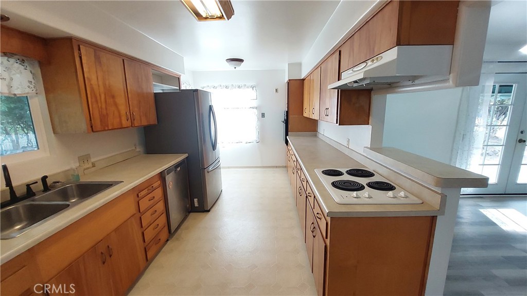 1909 Colusa Street Corning, CA 96021 - Photo 8 of 22 a kitchen with stainless steel appliances a stove a sink a refrigerator and cabinets
