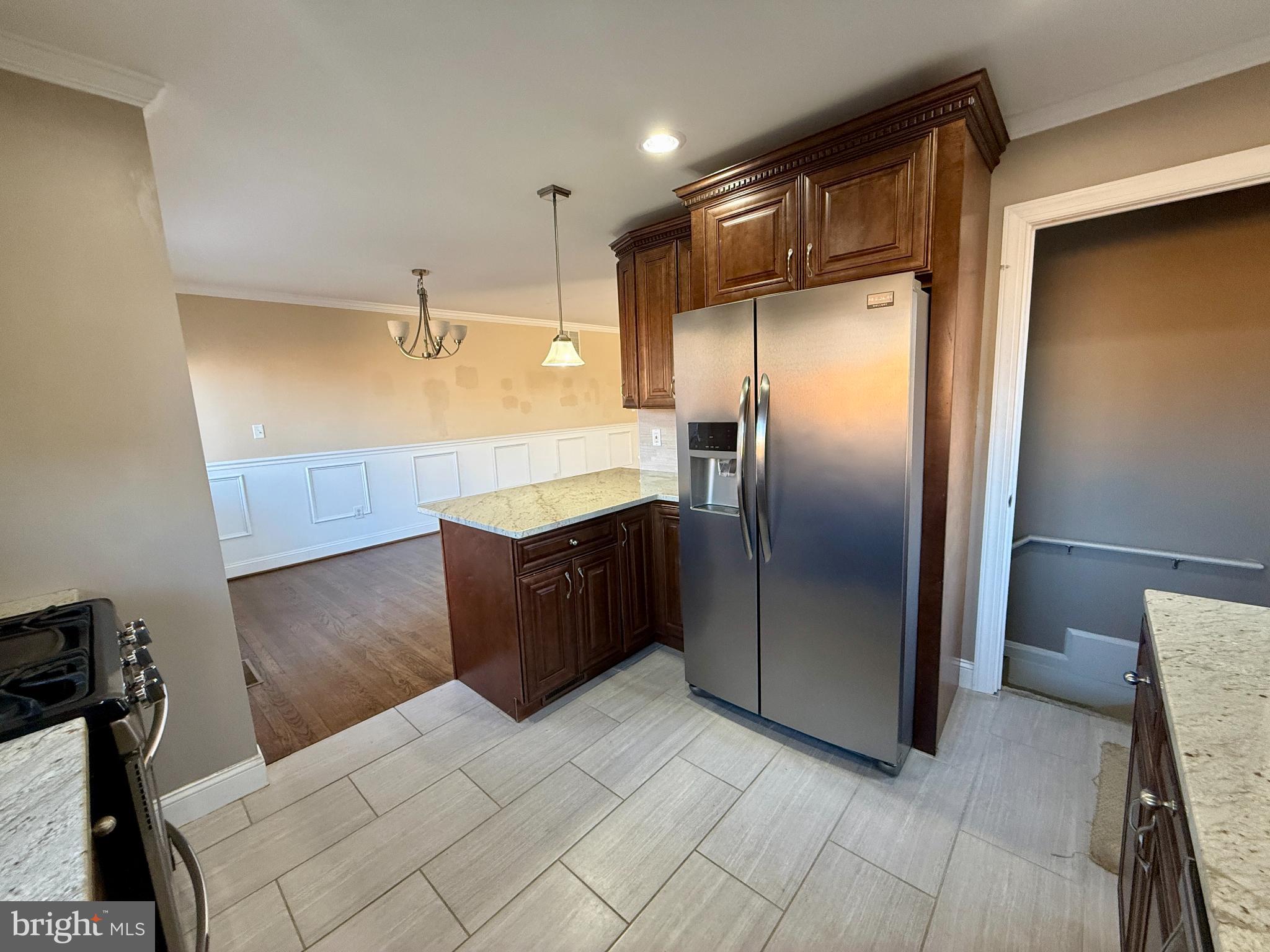 900 Southridge Road Catonsville, MD 21228 - Photo 12 of 31 a kitchen with granite countertop a refrigerator and a cabinets