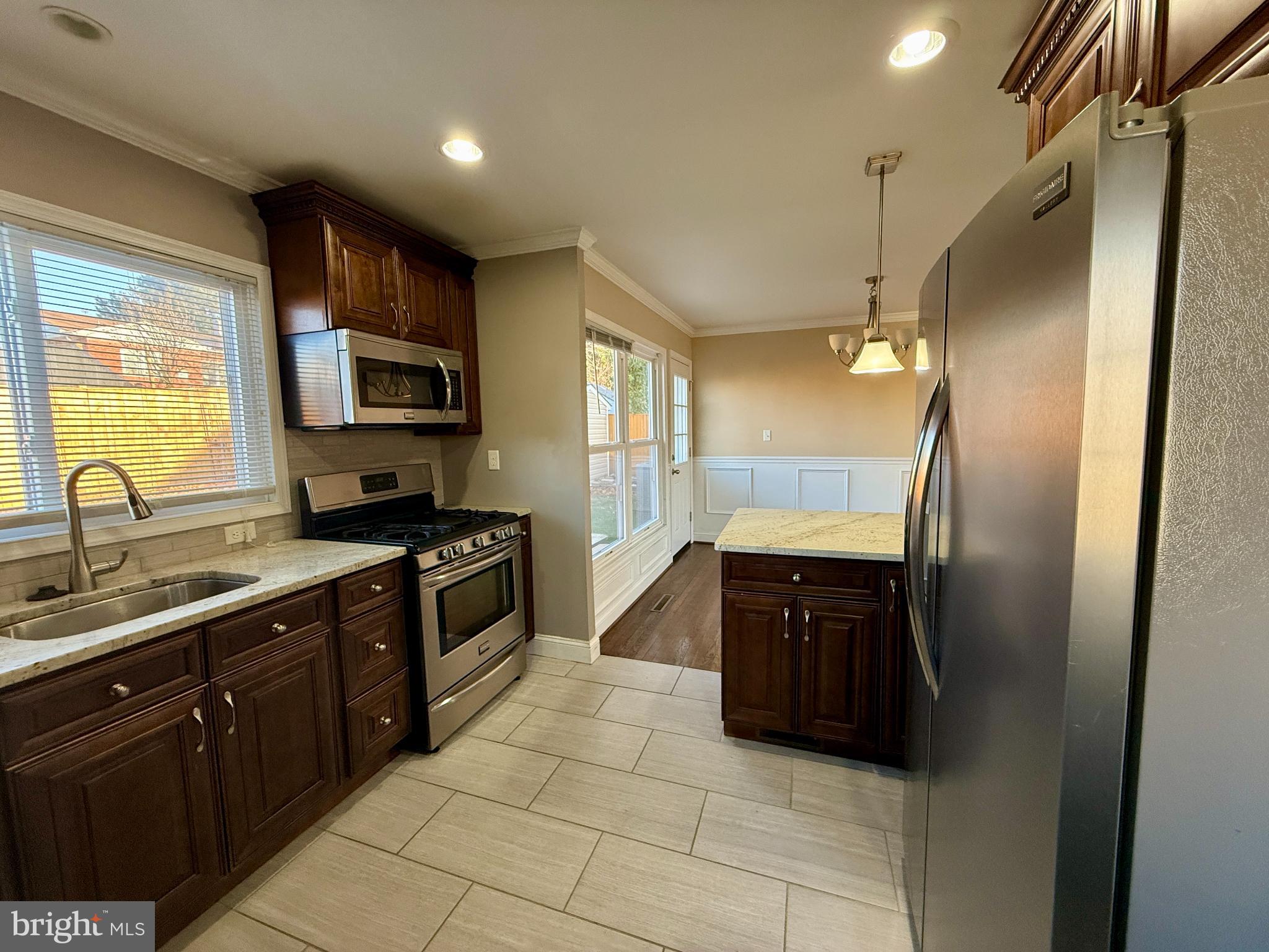 900 Southridge Road Catonsville, MD 21228 - Photo 14 of 31 a kitchen with a refrigerator and a sink