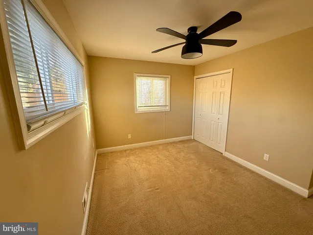 a view of empty room with ceiling fan