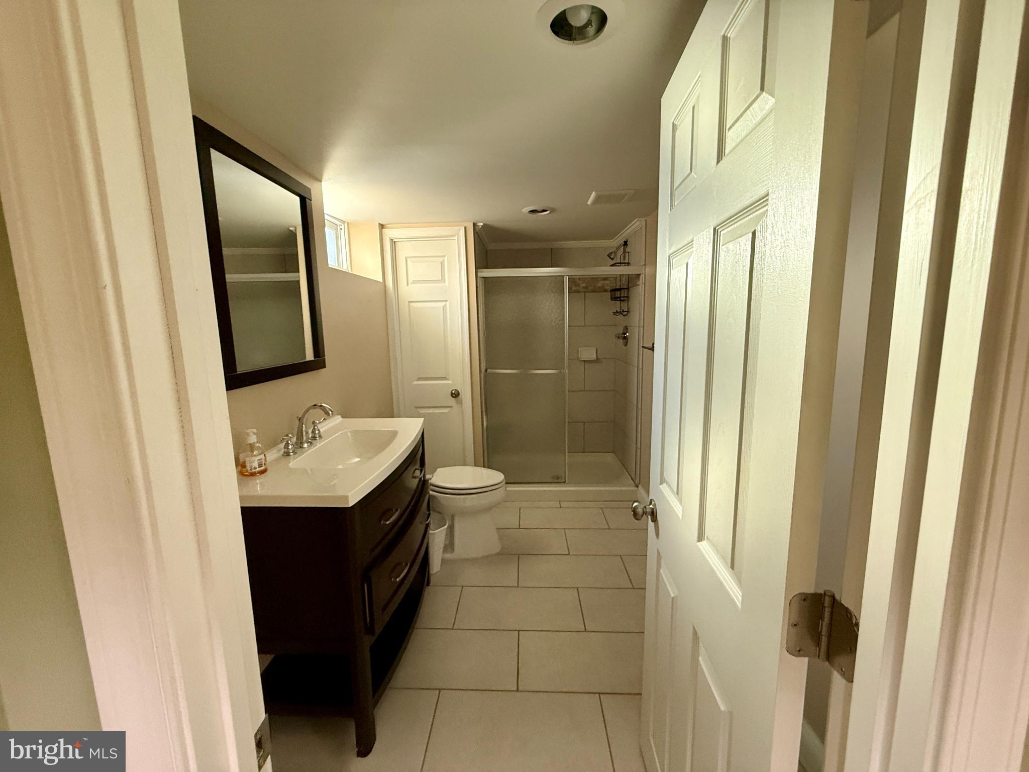 900 Southridge Road Catonsville, MD 21228 - Photo 25 of 31 a bathroom with a granite countertop sink a mirror and a bathtub