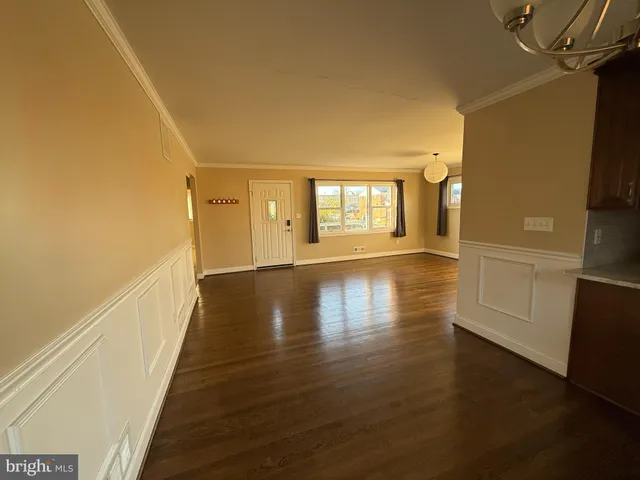 a view of hallway with stairs and wooden floor