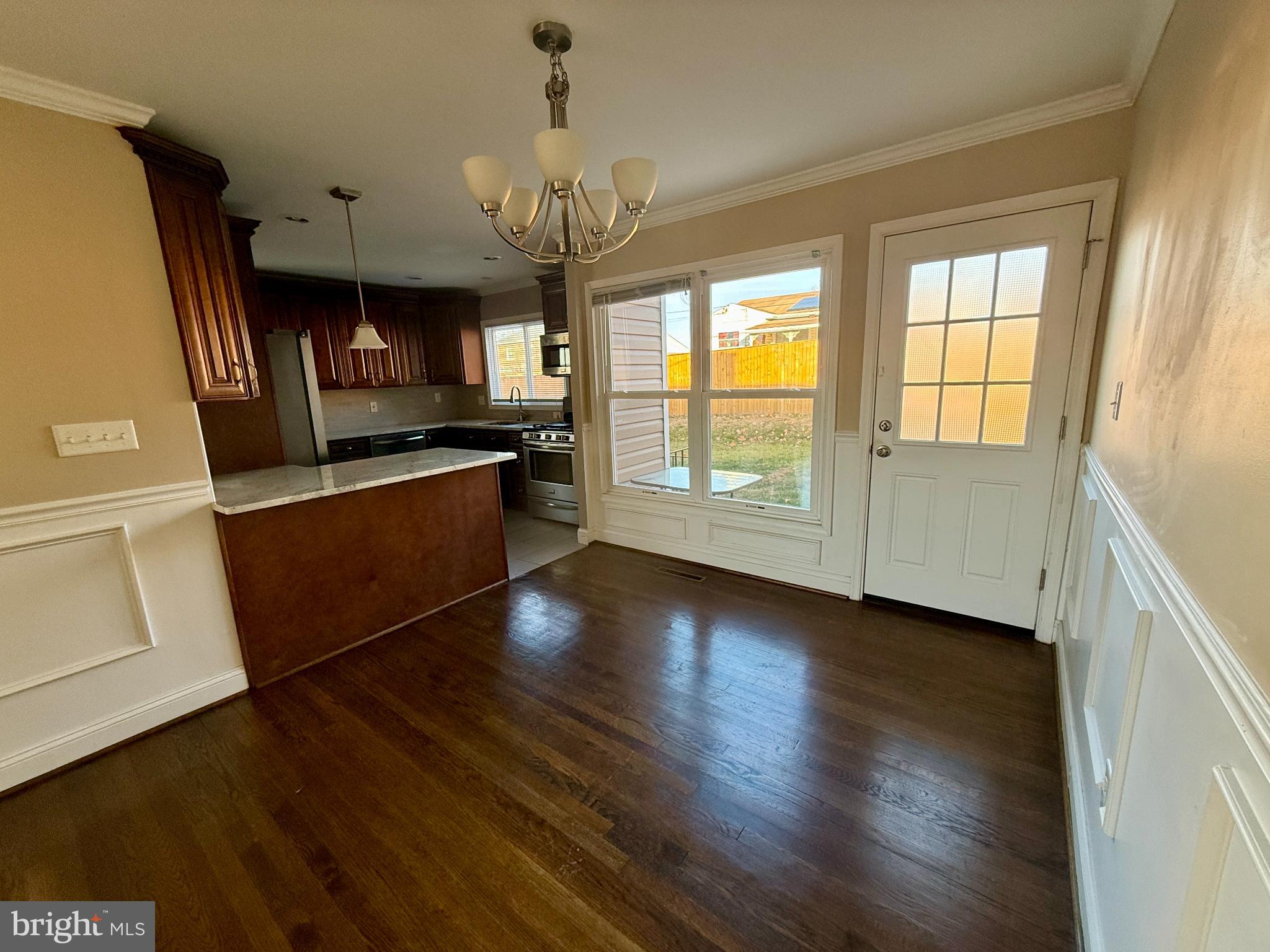 900 Southridge Road Catonsville, MD 21228 - Photo 9 of 31 an empty room with wooden floor and windows