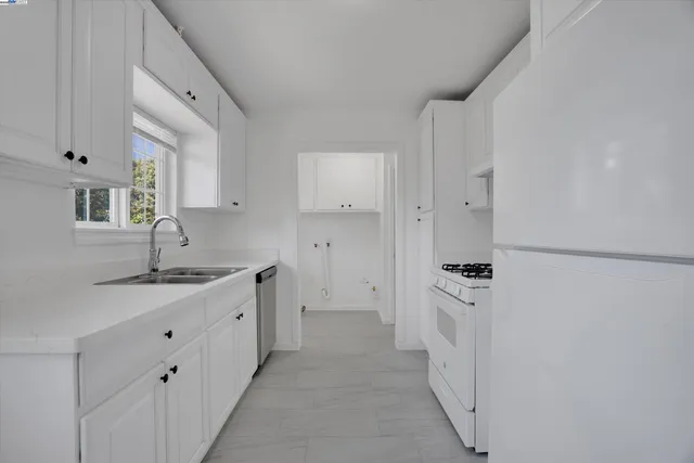 a spacious bathroom with a granite countertop sink and a mirror