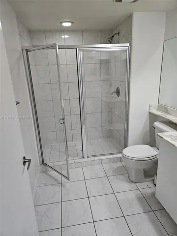 a bathroom with a toilet and a shower