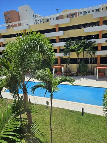 a swimming pool with outdoor seating and yard