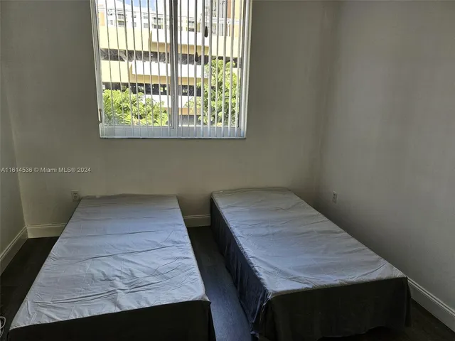 a view of a room with wooden floor and window