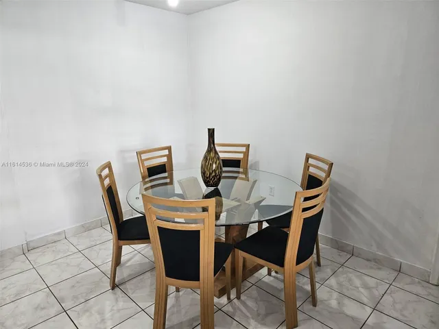 a view of a dining room that has a table and chairs in it