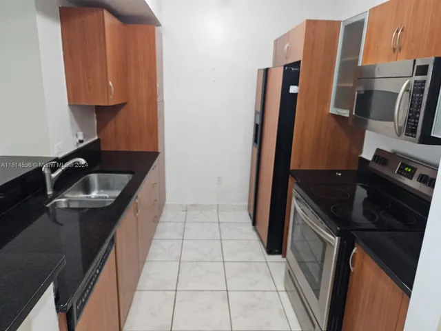 a kitchen with a sink stove and refrigerator