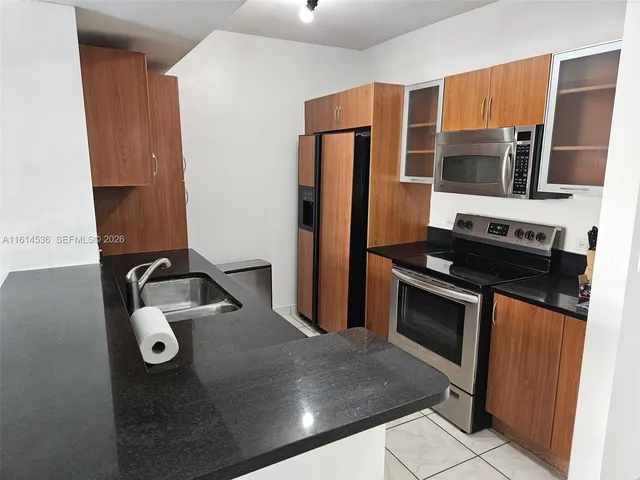 a view of balcony with plants and palm trees