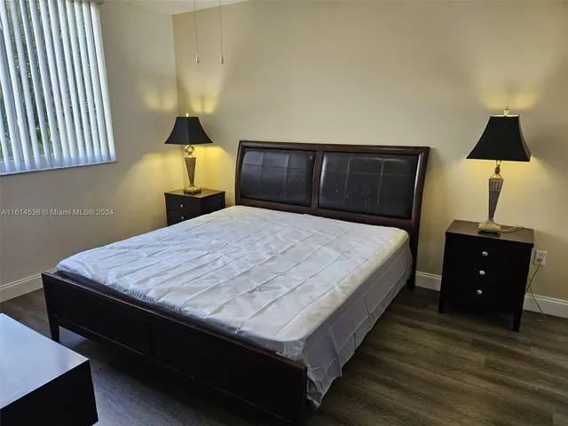 a bath tub sitting next to a white toilet and sink