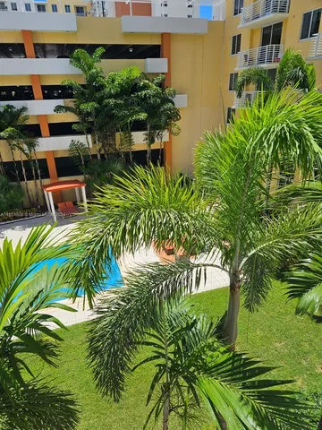 a view of backyard with outdoor seating and plants