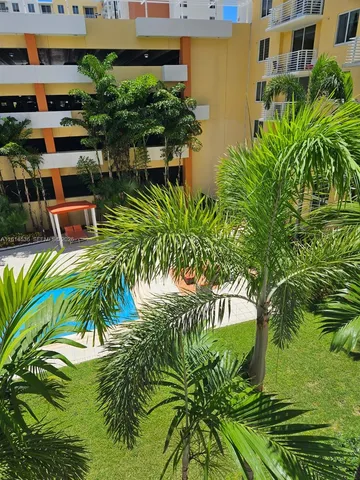 a view of backyard with outdoor seating and plants