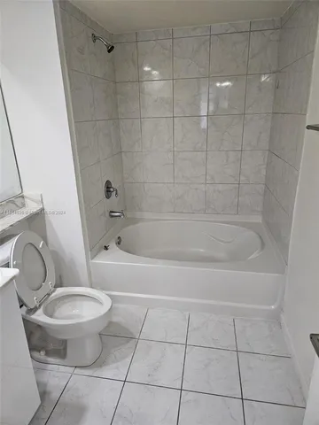 a bathroom with a toilet and a bathtub