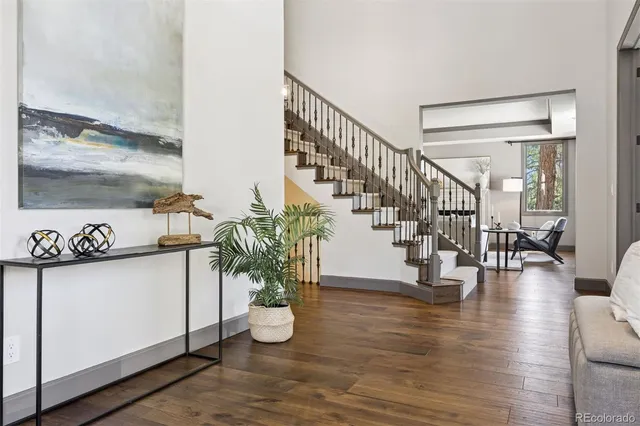 a view of entryway and hall with wooden floor
