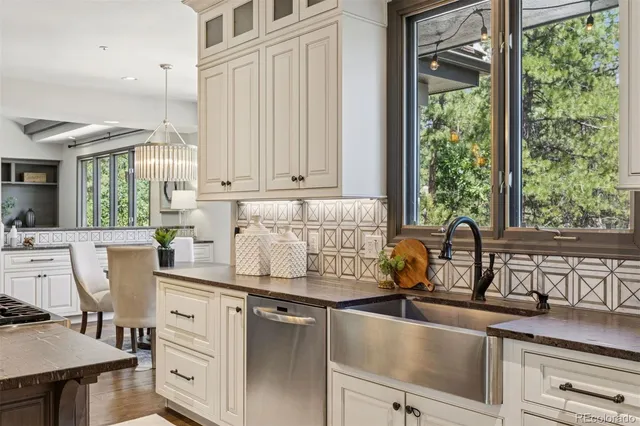 a kitchen with kitchen island granite countertop a sink cabinets and window
