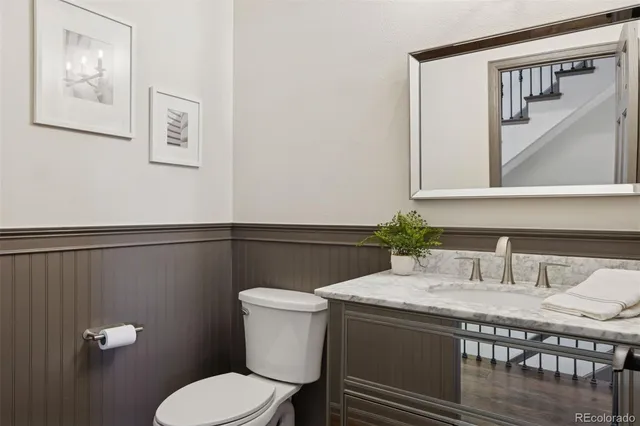 a bathroom with a toilet a sink and mirror