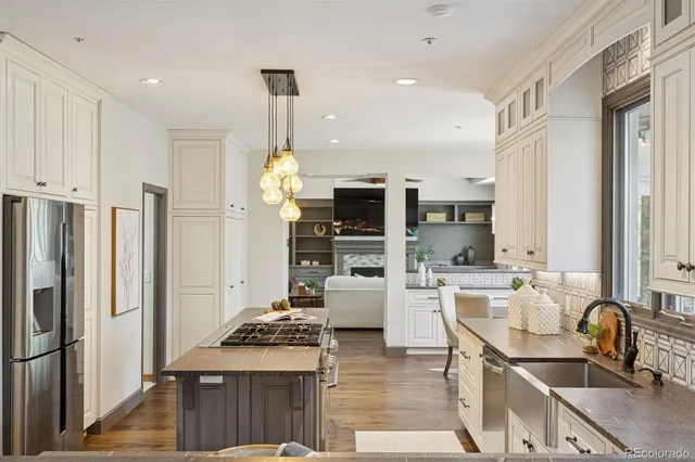 a kitchen with stainless steel appliances granite countertop a sink stove and refrigerator