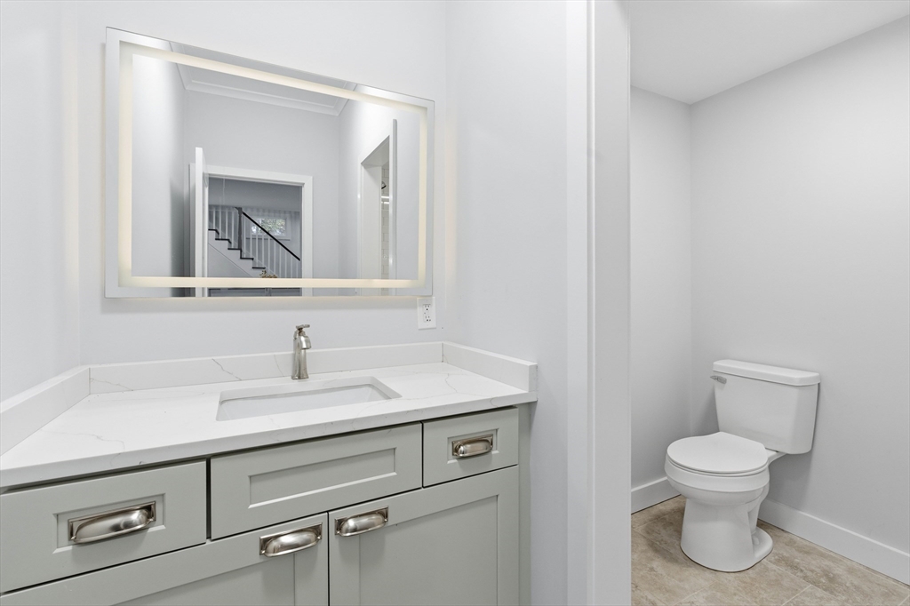 288 Grove Street, Unit 288 Clinton, MA 01510 - Photo 16 of 40 a bathroom with a toilet sink and mirror