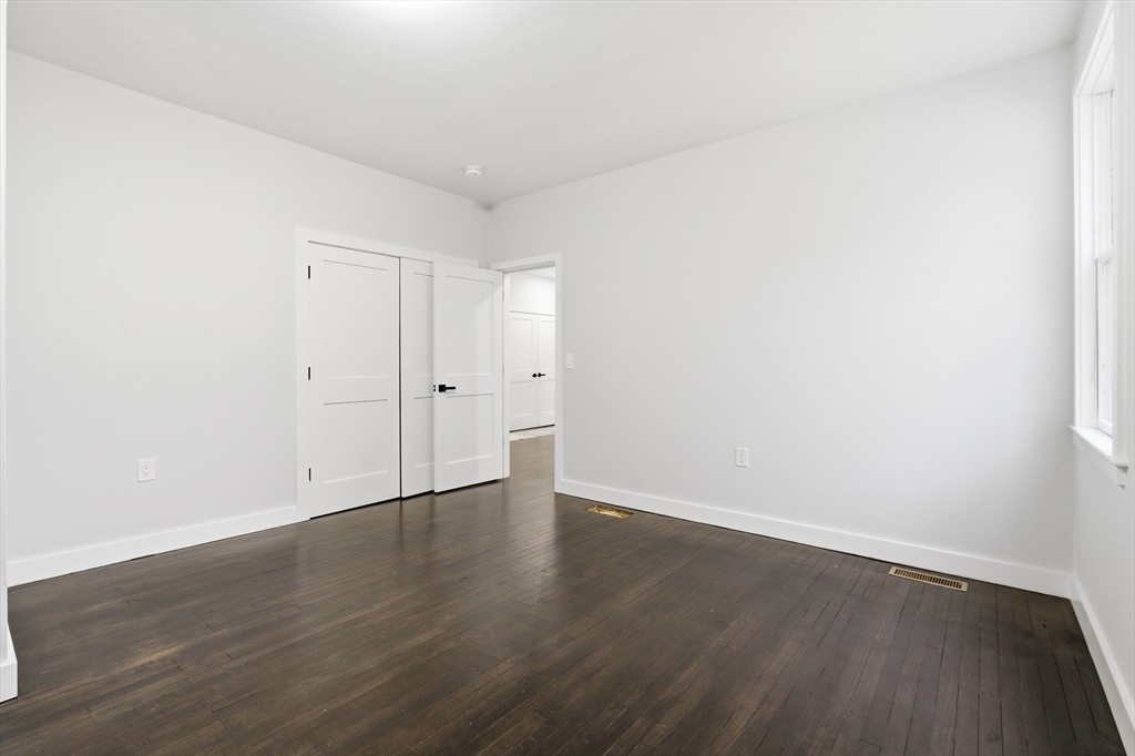 288 Grove Street, Unit 288 Clinton, MA 01510 - Photo 21 of 40 a view of an empty room with wooden floor