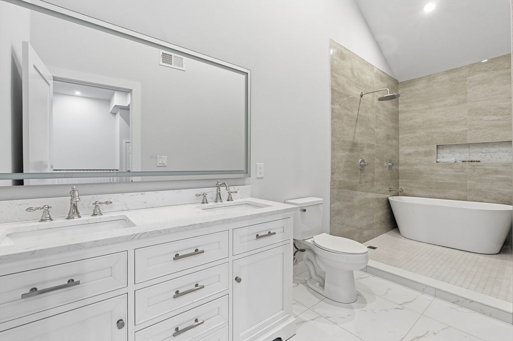 288 Grove Street, Unit 288 Clinton, MA 01510 - Photo 22 of 40 a bathroom with a toilet a sink a bathtub and a mirror