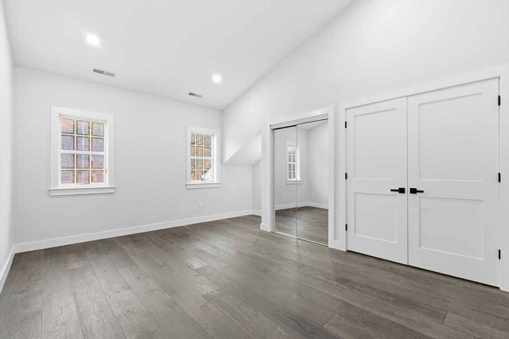 288 Grove Street, Unit 288 Clinton, MA 01510 - Photo 25 of 40 a view of an empty room with wooden floor and a window