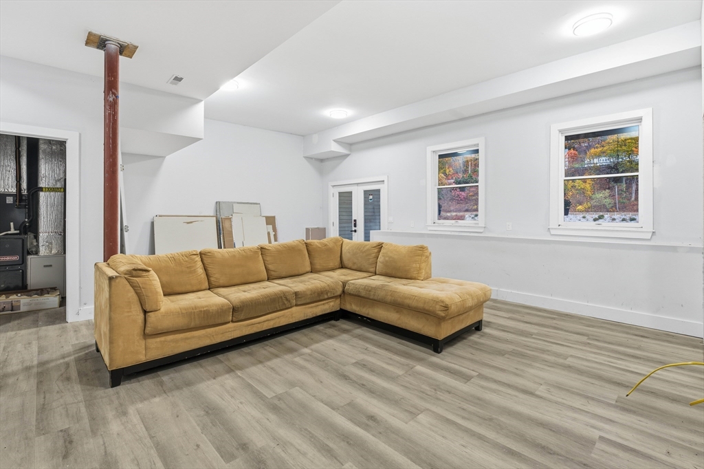 288 Grove Street, Unit 288 Clinton, MA 01510 - Photo 27 of 40 a living room with furniture and a wooden floor