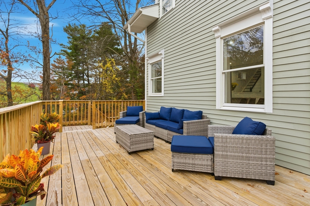288 Grove Street, Unit 288 Clinton, MA 01510 - Photo 31 of 40 a view of roof deck with couches and wooden floor