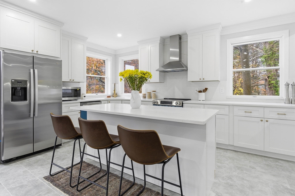 288 Grove Street, Unit 288 Clinton, MA 01510 - Photo 7 of 40 a kitchen with stainless steel appliances a dining table chairs refrigerator and sink
