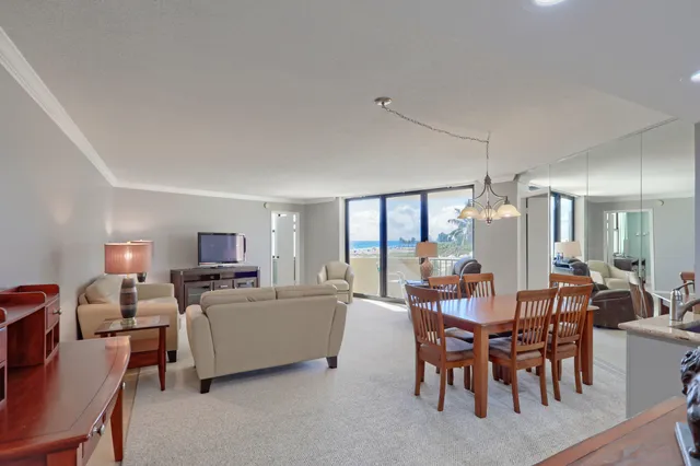 a view of a dining room with furniture and chandelier