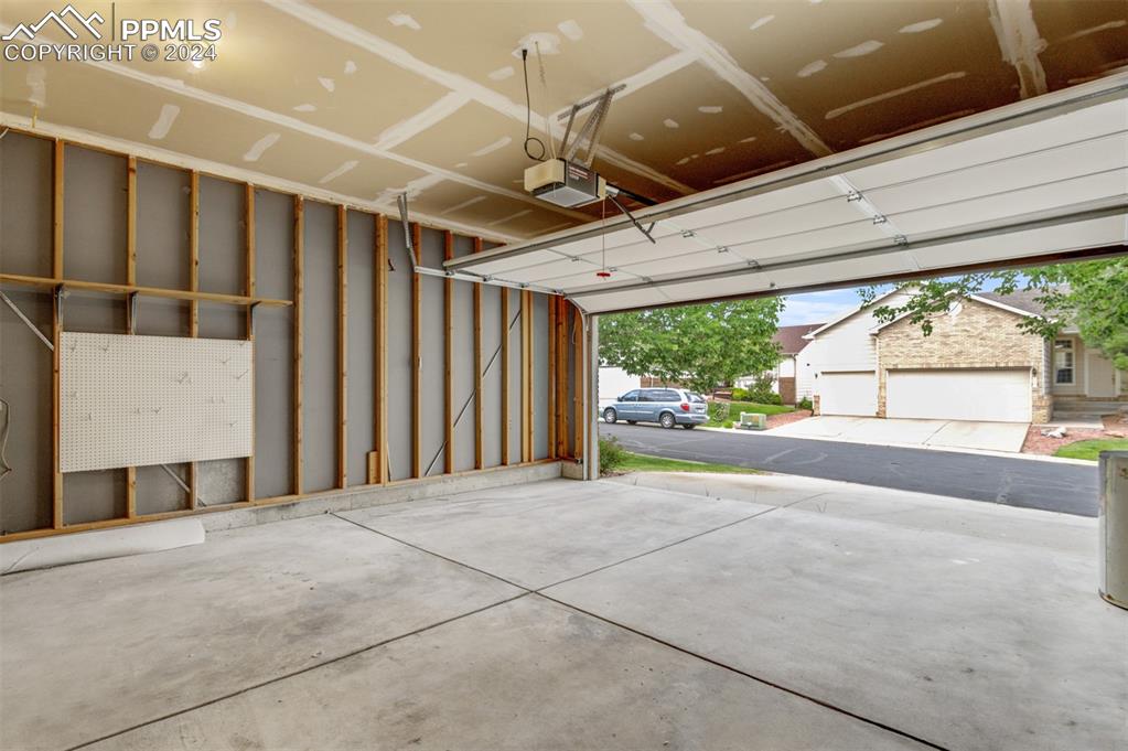 6385 Perfect View Colorado Springs, CO 80919 - Photo 24 of 35 Garage with a garage door opener