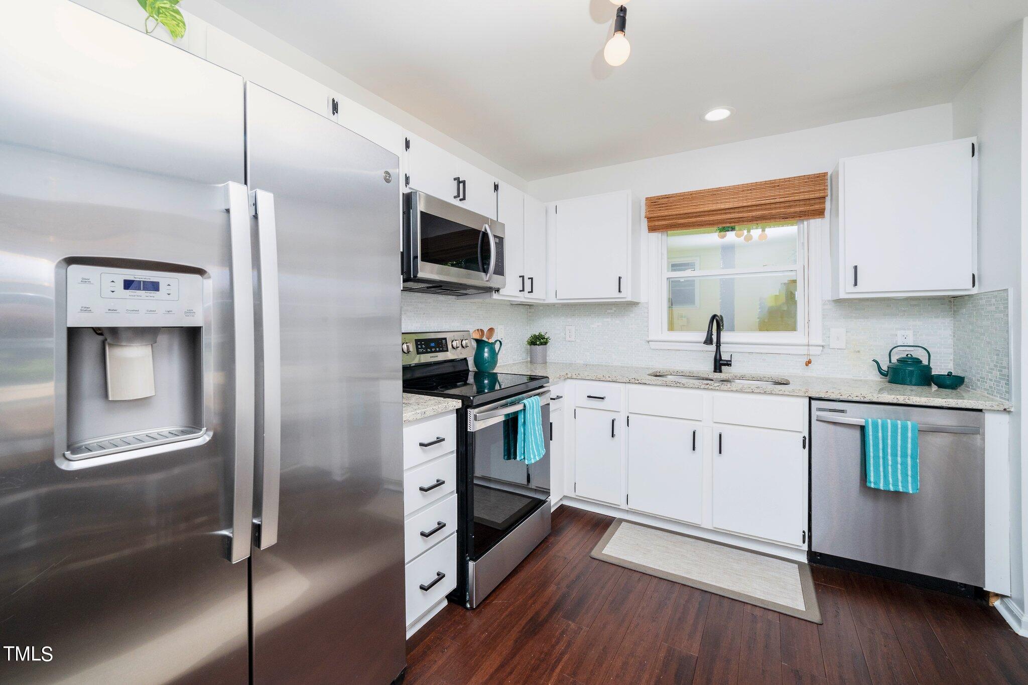 7 Little Spring Lane Durham, NC 27707 - Photo 11 of 25 a kitchen with stainless steel appliances a refrigerator sink and microwave
