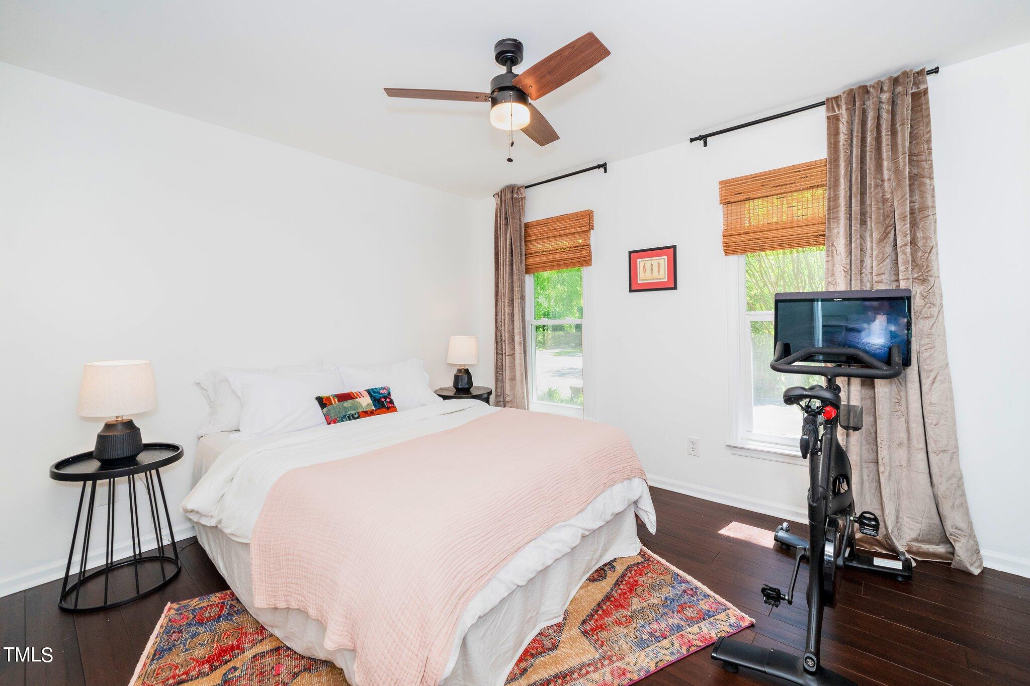 7 Little Spring Lane Durham, NC 27707 - Photo 17 of 25 a bedroom with a bed and a flat screen tv