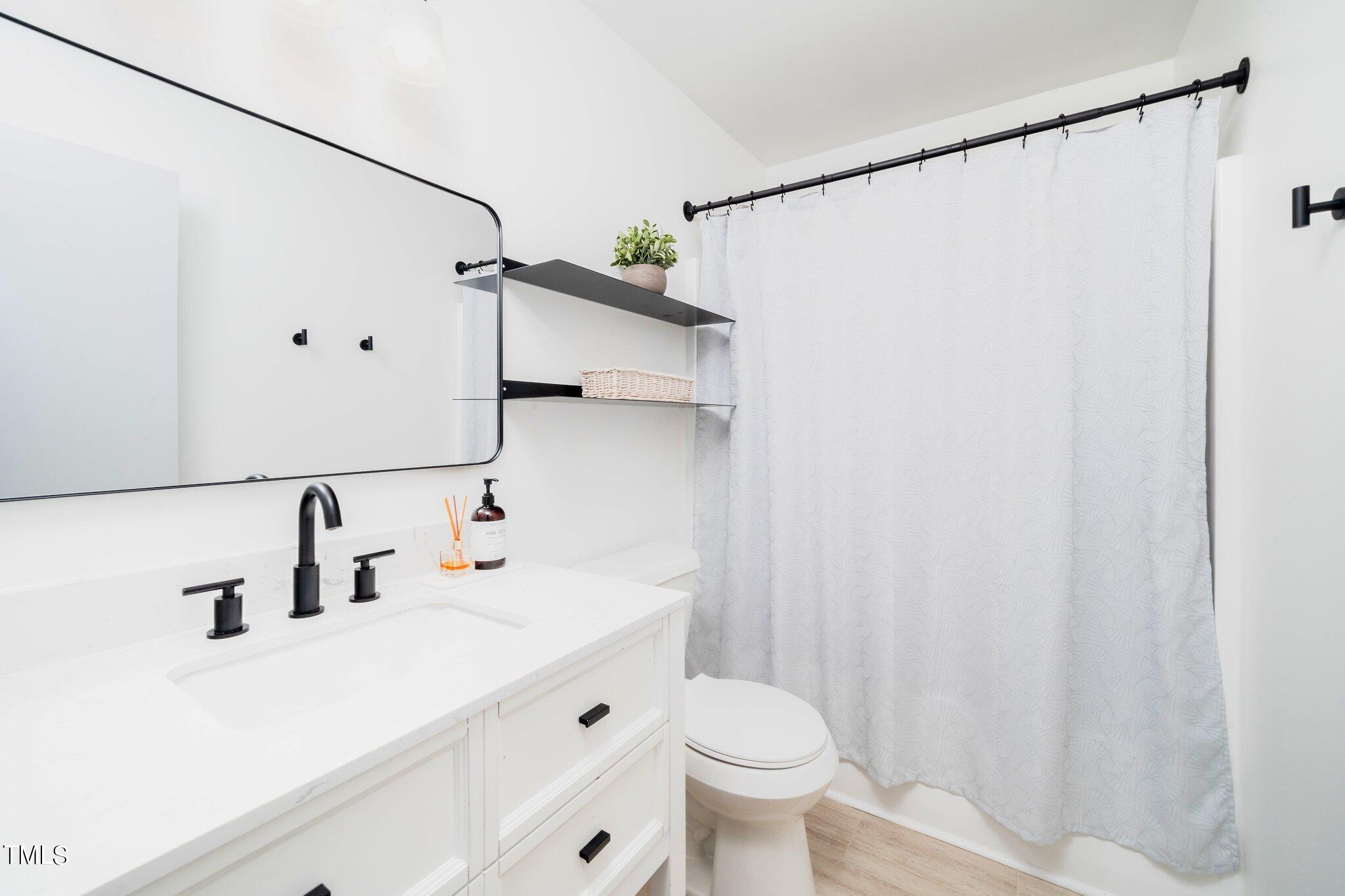 7 Little Spring Lane Durham, NC 27707 - Photo 18 of 25 a bathroom with a sink and a mirror