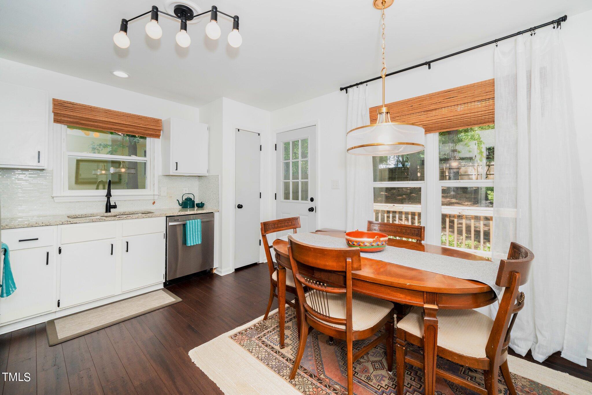 7 Little Spring Lane Durham, NC 27707 - Photo 10 of 25 a dining room with a table chairs and kitchen view