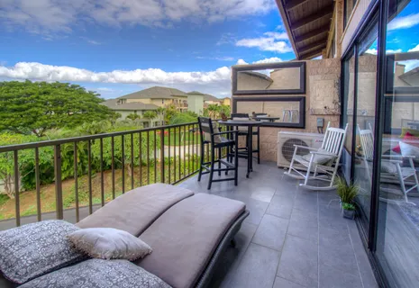 a balcony with furniture and a floor to ceiling window