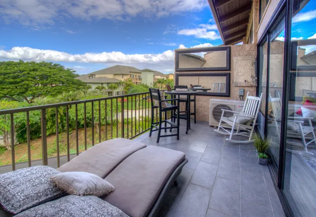 a balcony with furniture and a floor to ceiling window